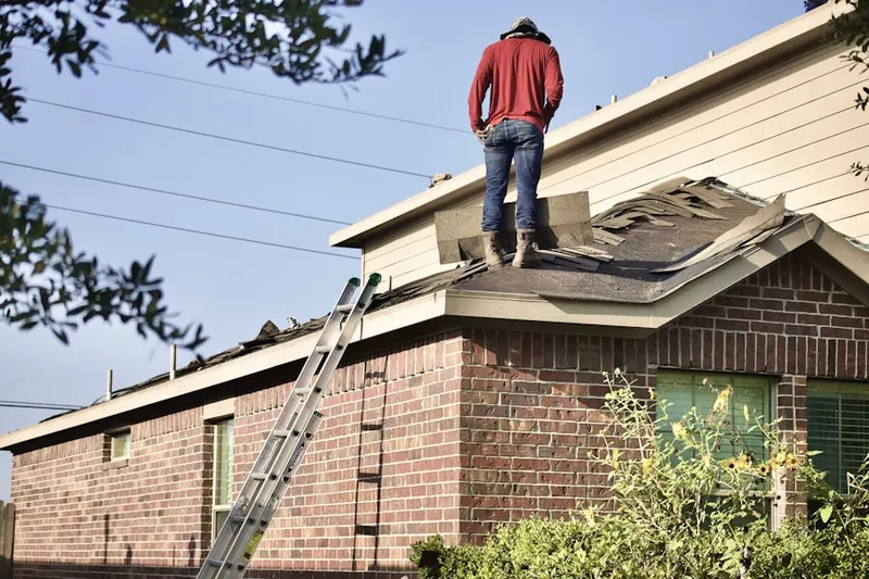 Professional roofer working on a residential roof in Bedminster